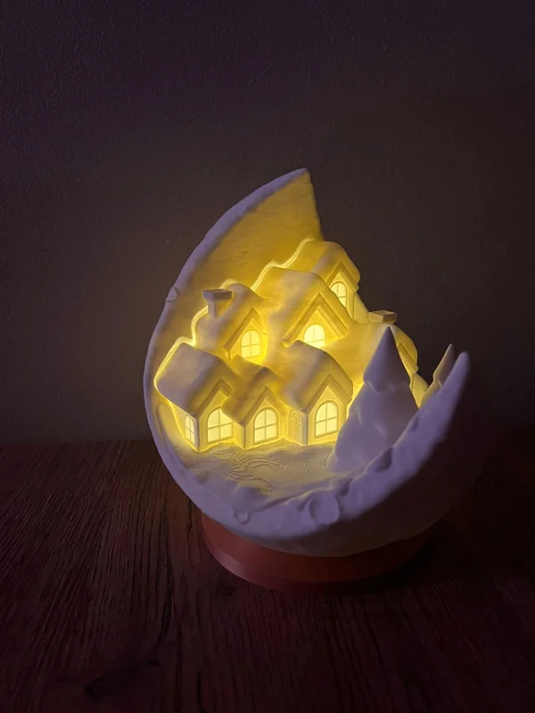 Kerstdorp in de vorm van een maan met LED-licht